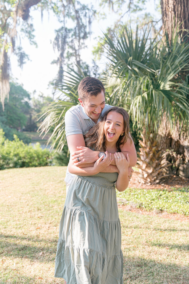 Couple hugging and laughing during portrait session for Palmetto Bluff Photographer Lamp and Light Photography.