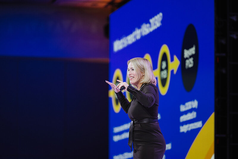 women key note speaker on stage 