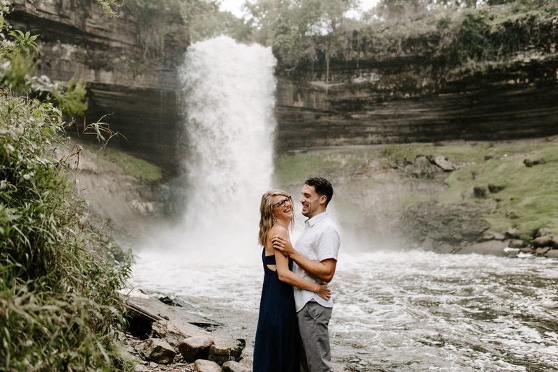 Couple laughing in front of Minnehaha Falls