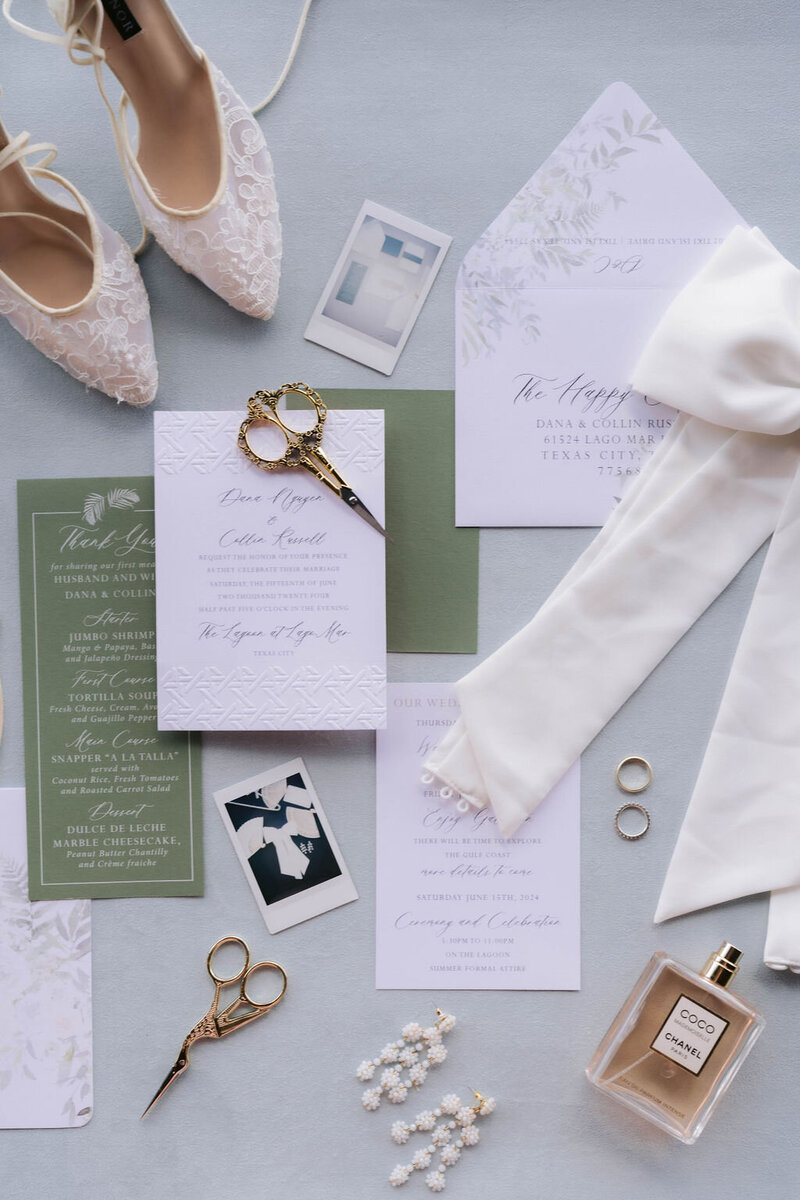 Outdoor stage featuring blush fabric draping, white tiered risers, and spring florals on green turf.