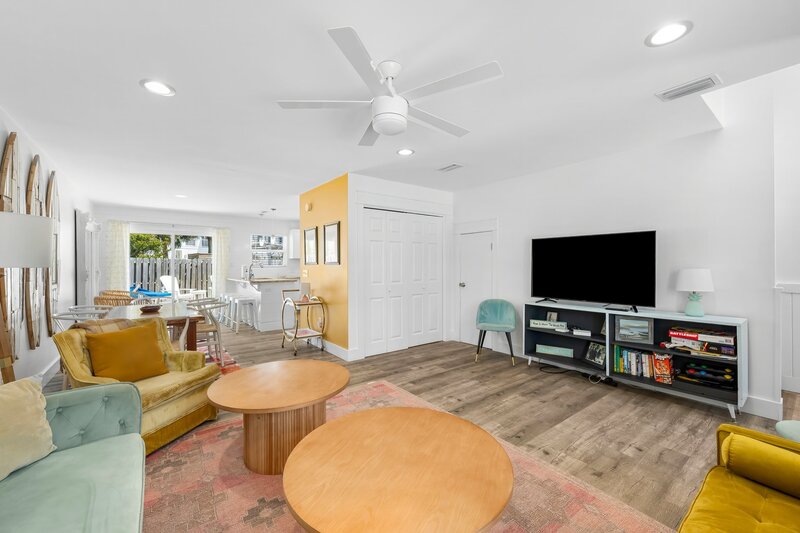 Spacious living area with smart TV, bookshelf, and plenty of seating—perfect for relaxing after a day at the beach.