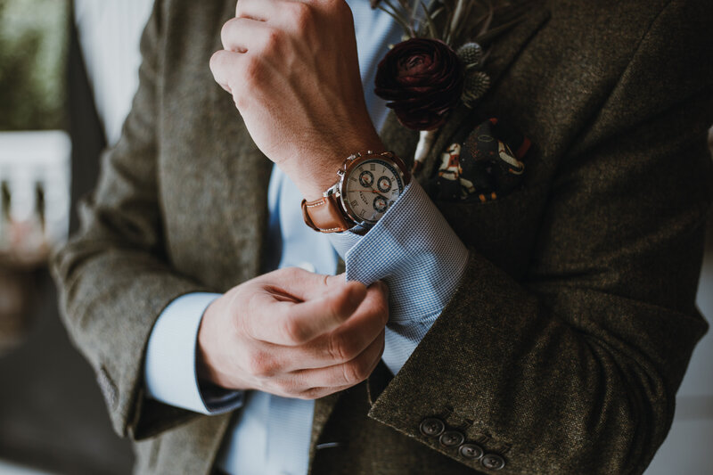 groom adjusting watch