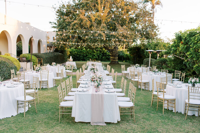 13-radiant-love-events-outdoor-reception-white-tables-on-grass-marquee-lights-romantic-elegant-timeless