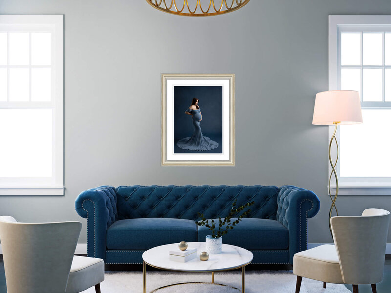 portrait of pregnant woman hanging on the wall over a couch