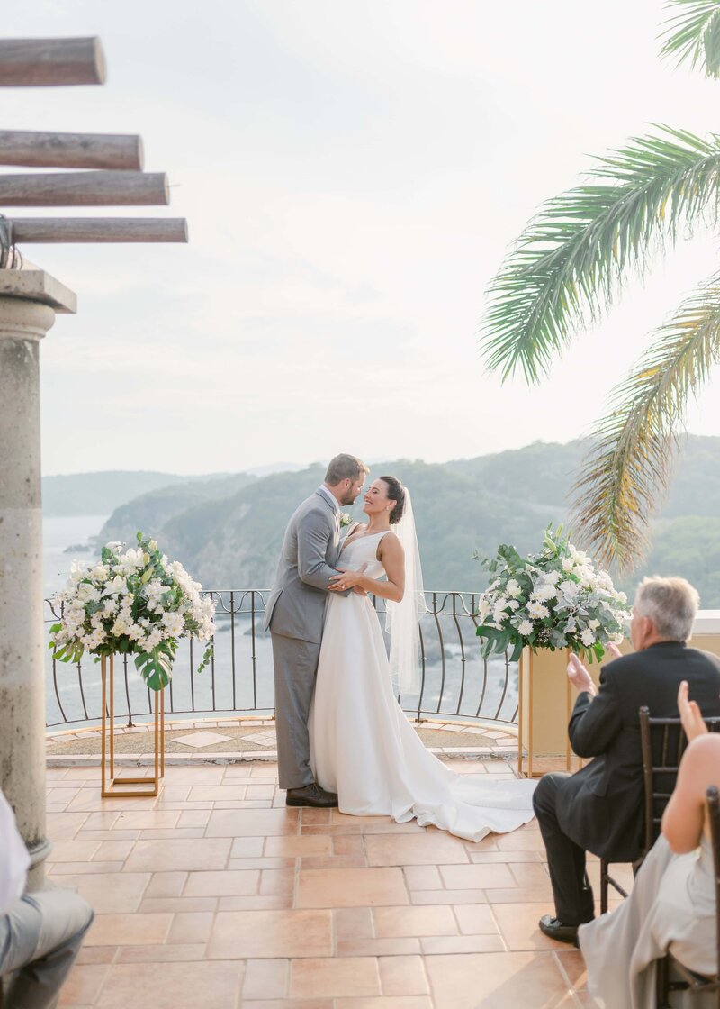 bride and groom about to kiss in huatulco, mexico