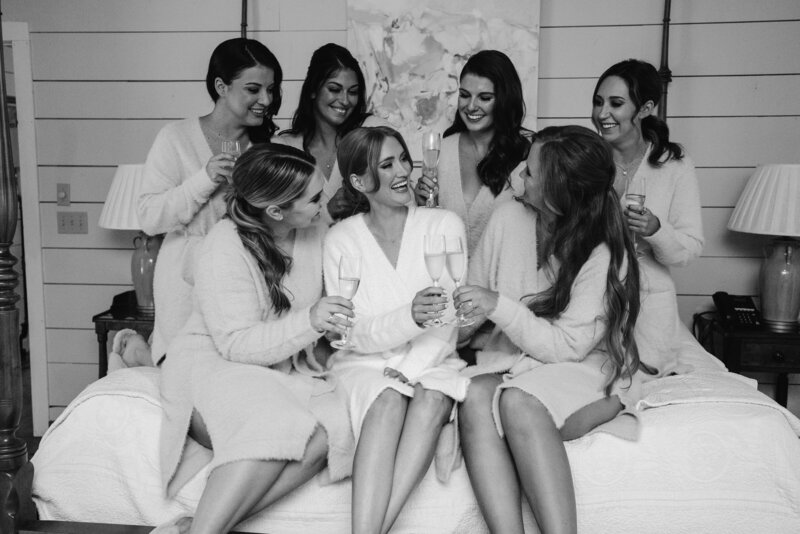 Maddie Moore Photography captures bridesmaids drinking mimosas at The Farm at Old Edwards Inn