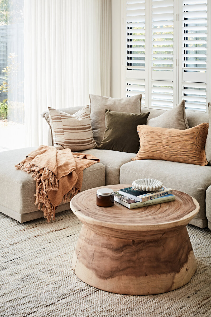 Modern lounge with warm neutrals styled for relocation project by Melbourne interior decorator service.