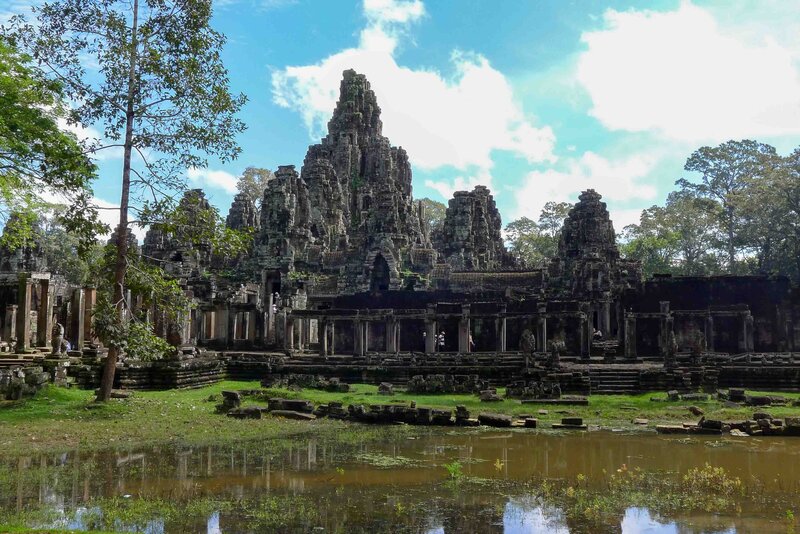 Ancient stone temple ruins with towering spires and crumbling galleries in Angkor, Cambodia ©Stephanie Dosch | theViatrix Luxury Travel