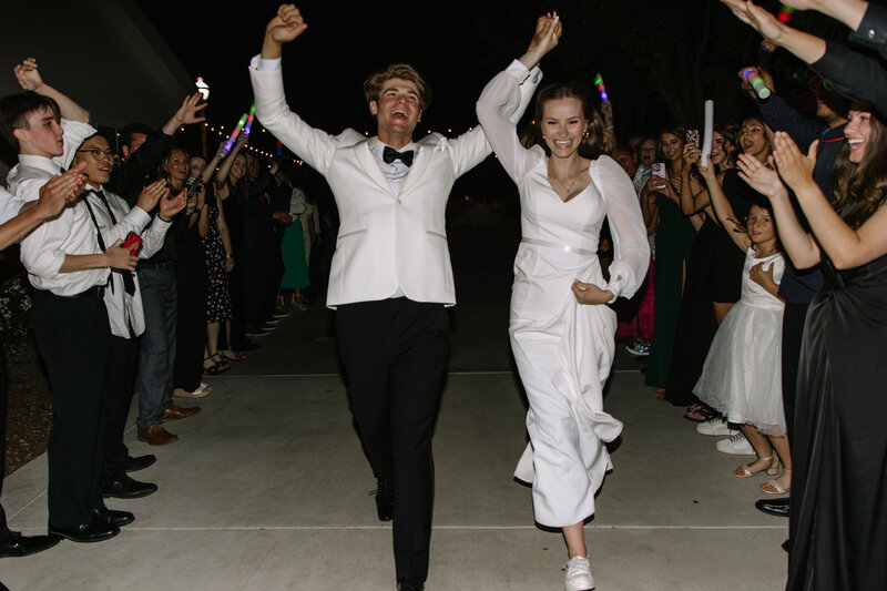 Payton and Evan exiting their wedding.