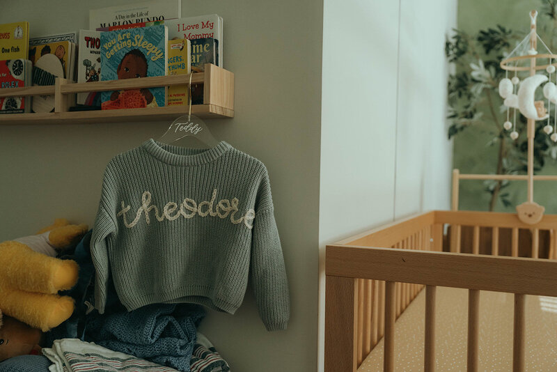 tiny sweater with embroidered name during newborn photoshoot captured by NYC maternity and newborn photographer Elsie Goodman 