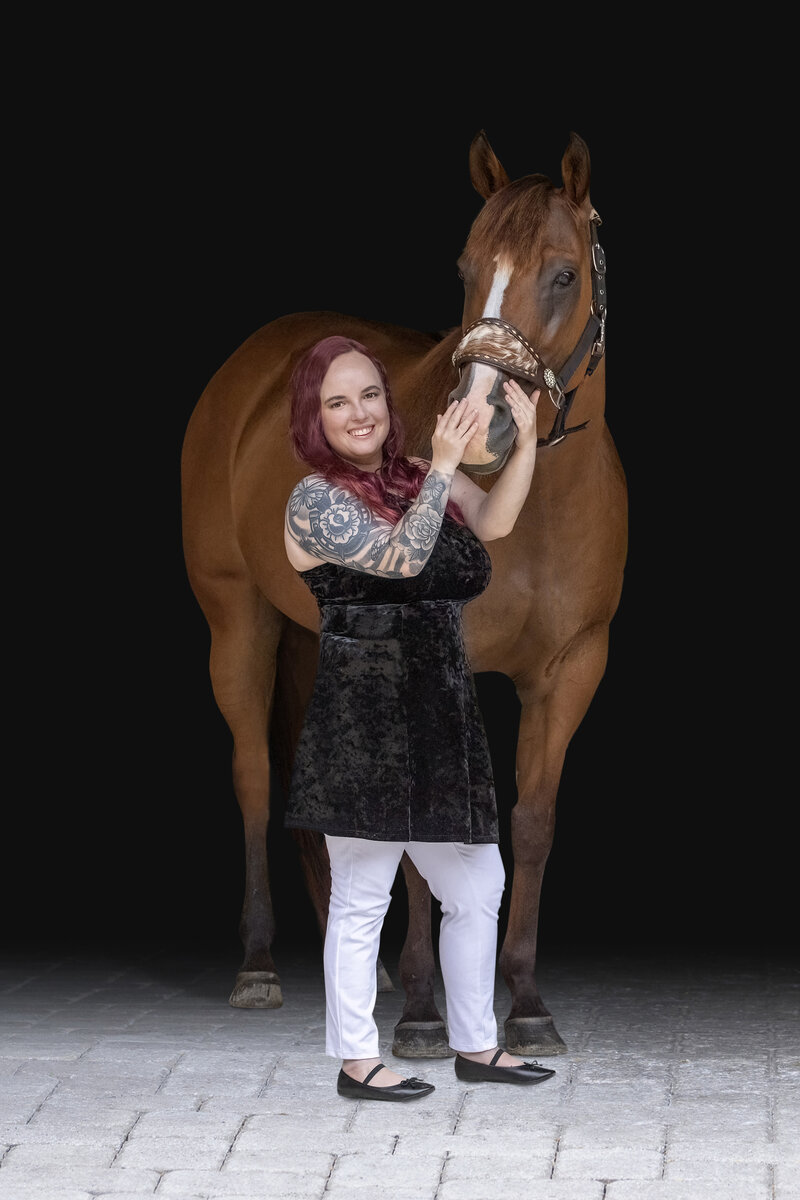 South Florida Professional Equine and Pet Photographer, Katy In Design, pictured next to her horse smiling
