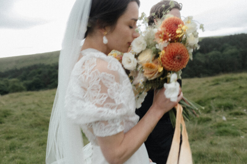 Bride holding colorful bouquet at Upper House Estate Derbyshire wedding, photographed by Luis Calow