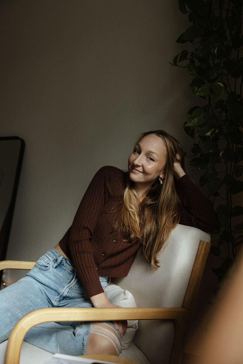 A Michigan wedding photographer's headshot with a minimal backdrop.