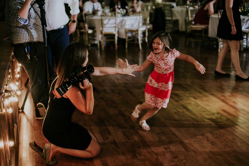 Photographer give little girl high five