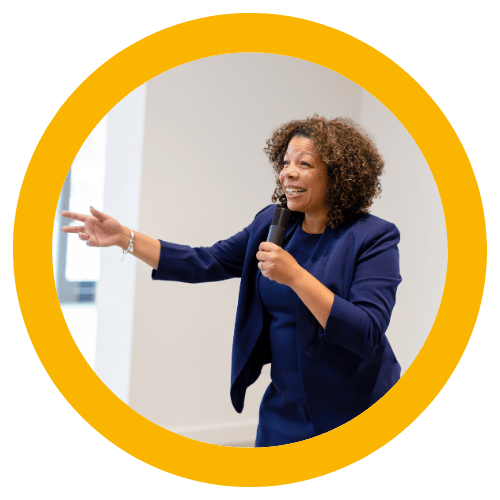 Photo of Michelle McKown-Campbell smiling while walking down a hall