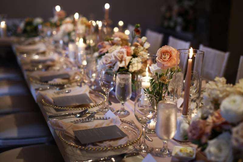 Wedding tablescape with lush florals and candles.