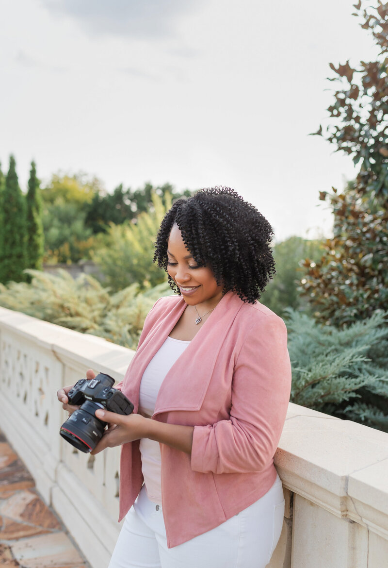 Elegant portrait of Lisa Yvette holding photography equipment