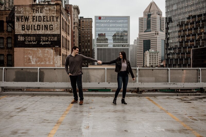couple holding hands on the rooftop