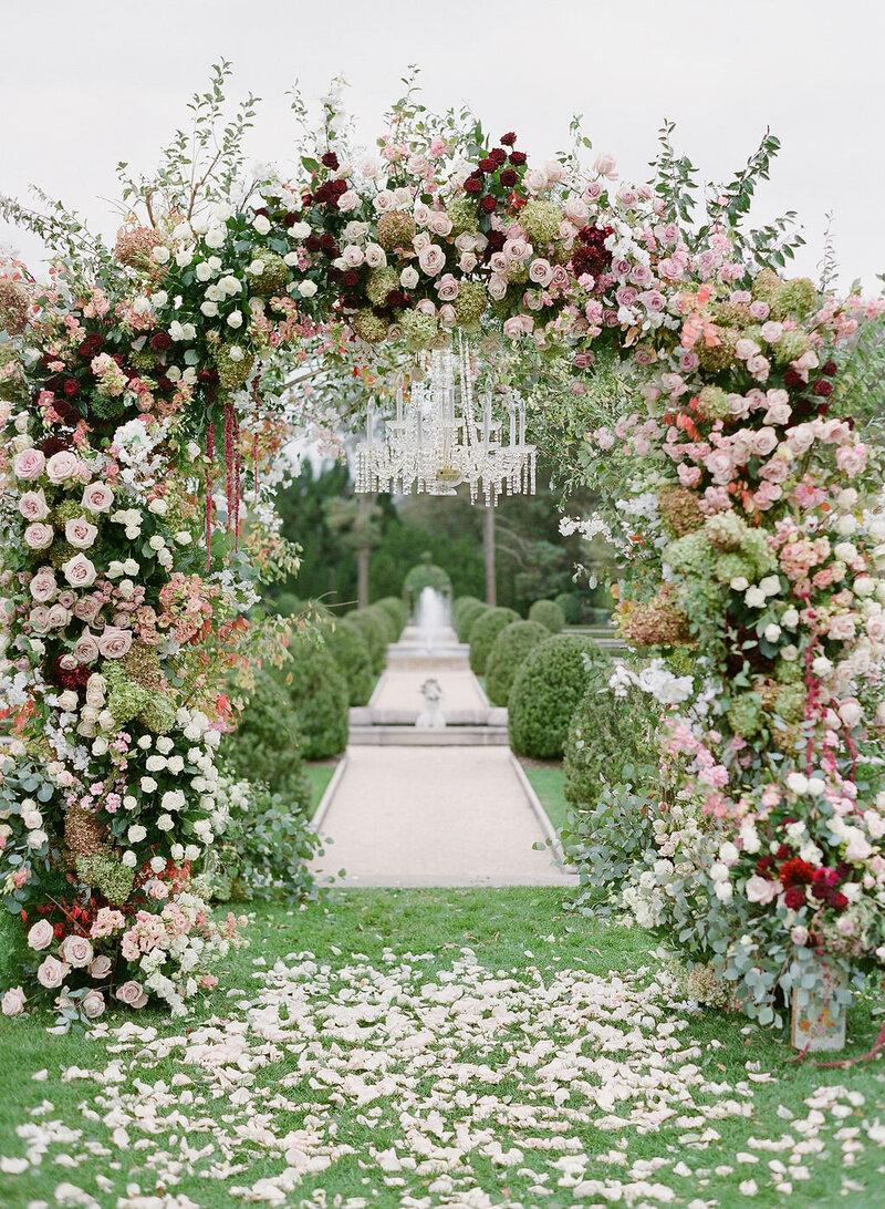 Lush Floral Wedding arch in pink and red Oheka Castle
