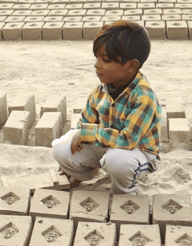 Enslaved child creating bricks at the kiln.