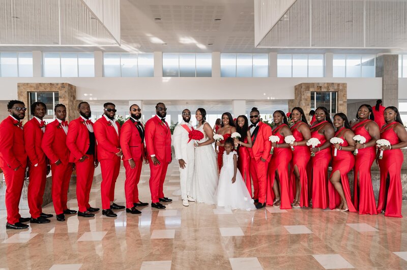 Wedding party in red and white attire.