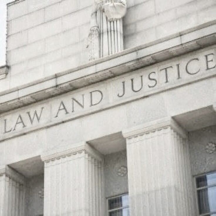 alt="Law and Justice building with columns, displayed with contact information overlay"
