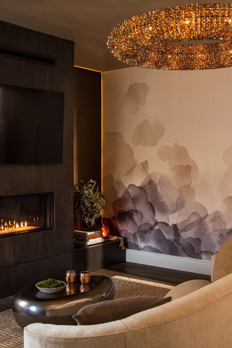 Interior brand photography of a luxurious living room with fireplace and chandelier.