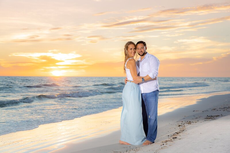 Engaged couple on Siesta Key Beach at Sunset taken by Love and Style Photography