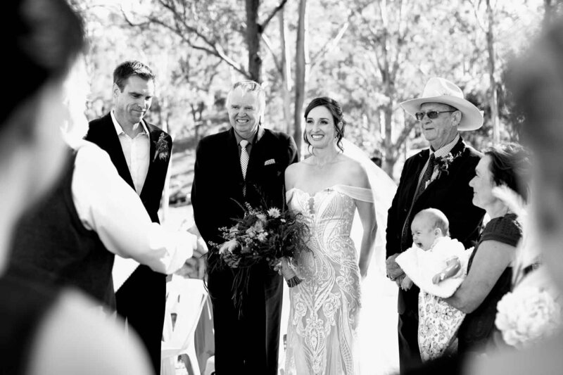 Wedding couple and guests at wedding ceremony