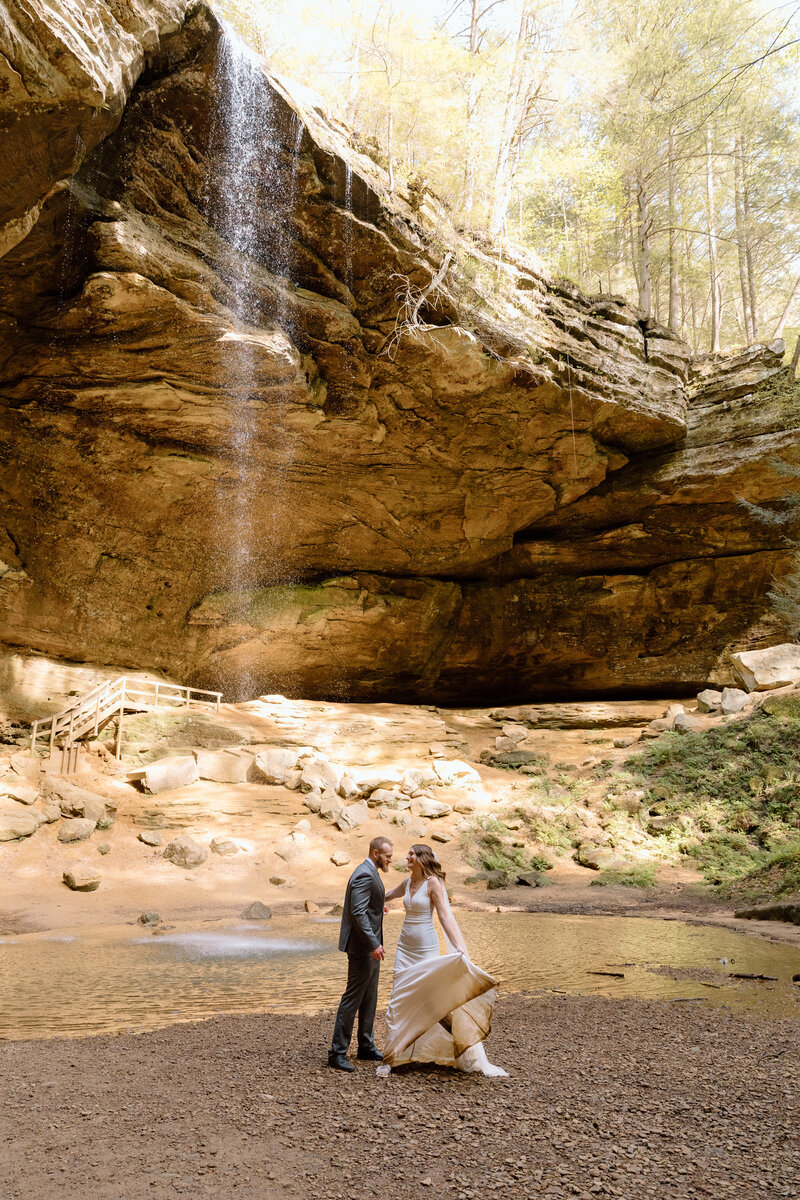 Couple dancing in front of the waterfall at Ash Cave.