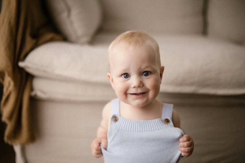 Baby oscar posing for a photograph during a baby photoshoot with aimee kelly photography in new plymouth