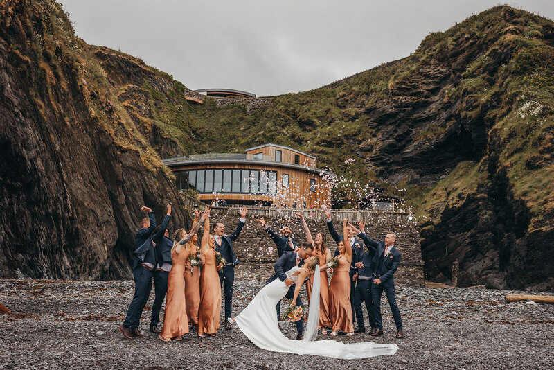 wedding party celebrate in front of venue