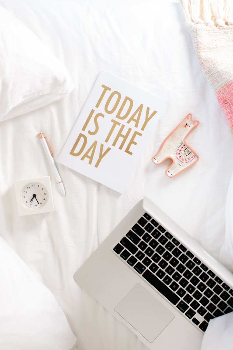 A stock image that states Today Is The Day with a tiny clock and a laptop for the sales page for The creative bookkeeping template for creatives by Dolly DeLong Education
