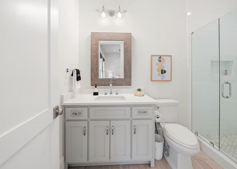 bathroom with gray cabinets