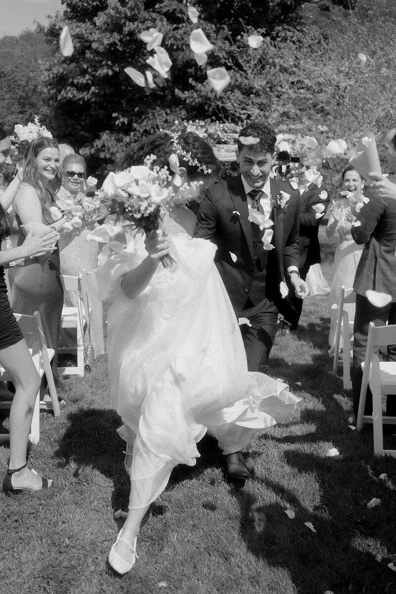 Destination elopement photographer captures bride and groom holding hands after downtown wedding