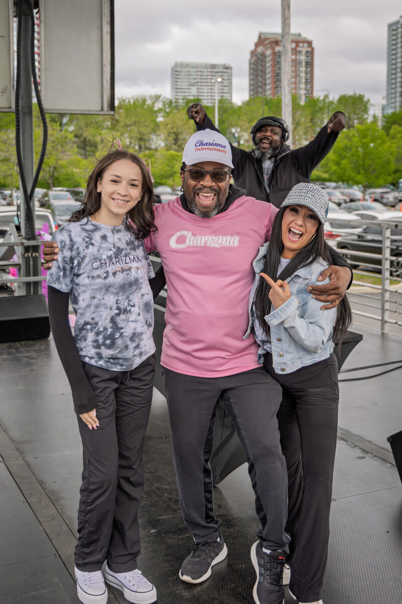 Performers leading a crowd from a stage