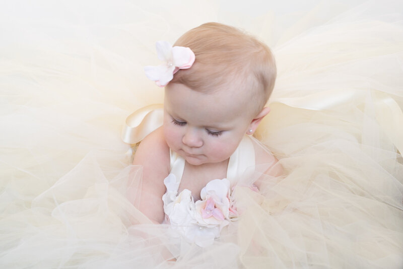 1st birthday portrait session in yellow tutu dress and pink flowers