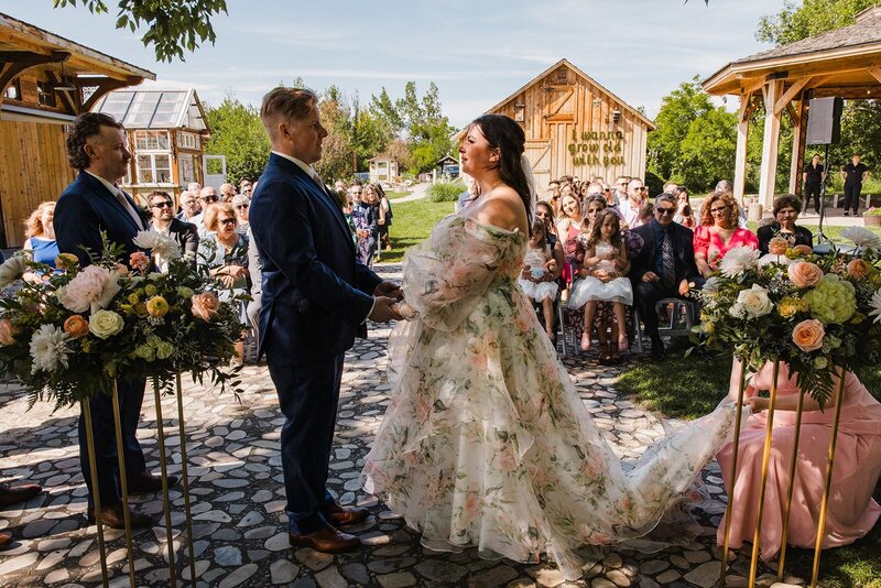 Couple getting married with their guests in the background.