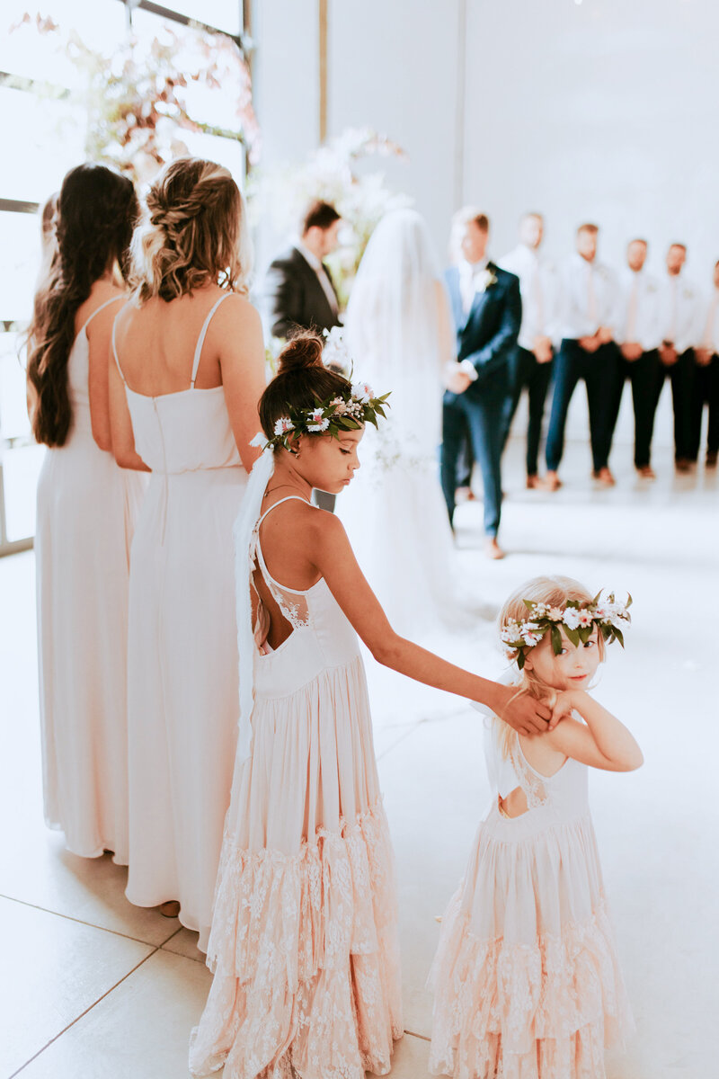 Shot of all the little bridesmaids standing at the altar.