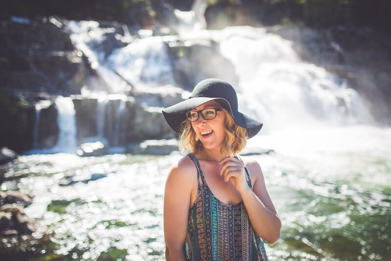 Vancouver Island photographer Chelsea Dawn smiling after a hike to a waterfall