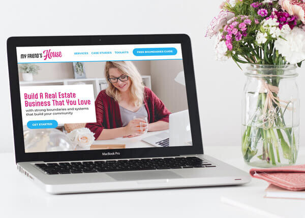 Example Of Brand Identity Creation in action - website design mockup on a laptop next to a vase of flowers