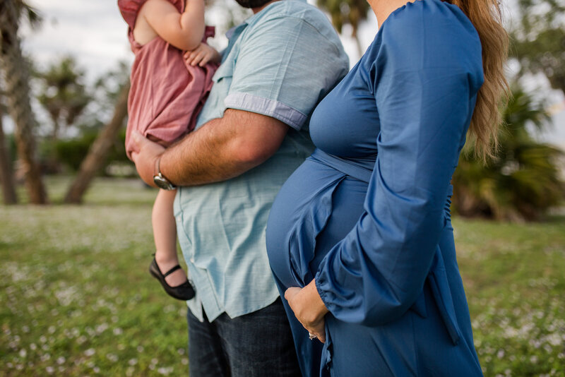 A brother and sister hold their newborn brother in Wauchula, Florida.