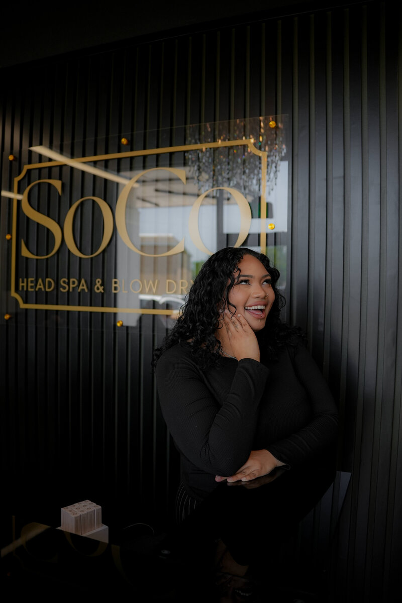 Guest checking in at SoCo Head Spa’s front desk, greeted by the team for a personalized, luxury wellness experience in Bryan, TX.