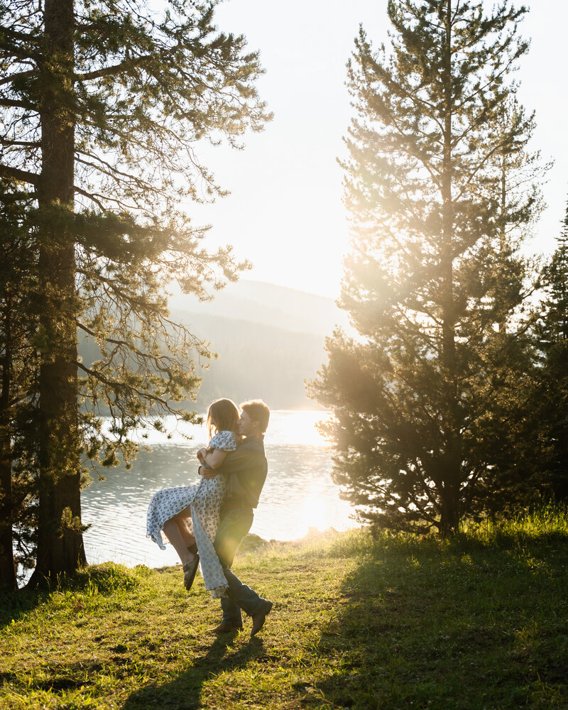 Montana couple laughing during a sunset photo session in the mountains