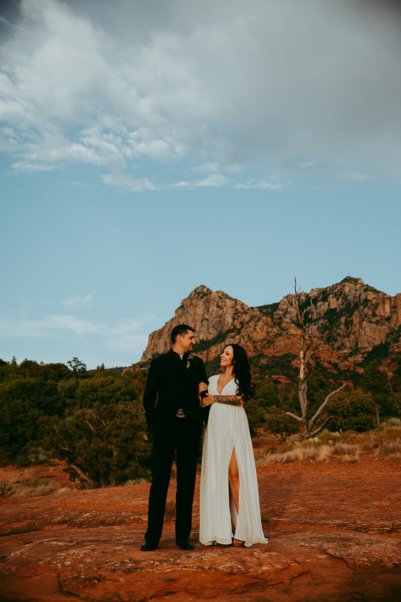 couple smiling on red rocks in sedona
