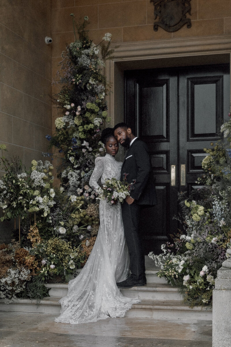 Wedding photographer captures couple taking a stroll hand in hand at their french chateau wedding.