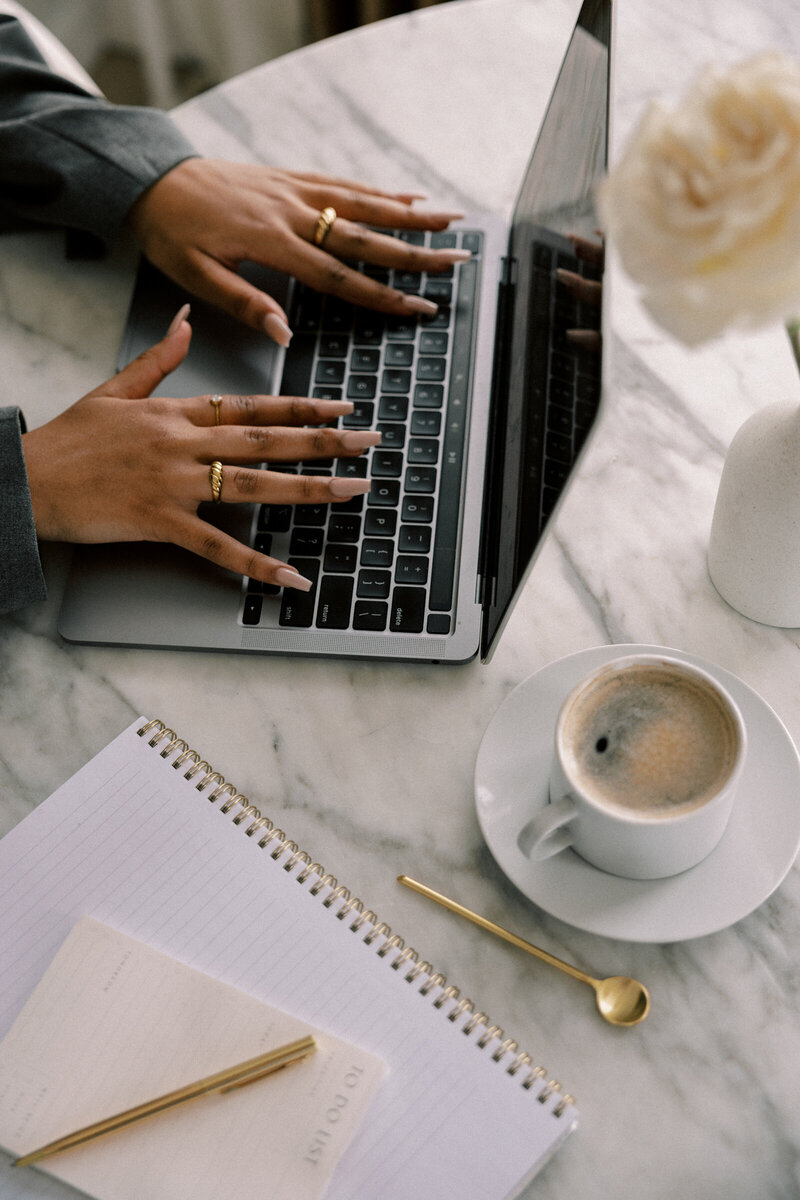 woman planning out her business goals on a calendar and notepad