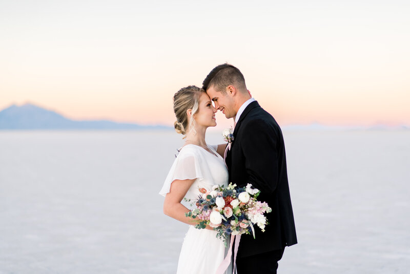 Soft romantic couple nose to nose smiling on during their Utah Wedding at the Bonneville Salt Flats taken by Utah wedding photographer Andria Joleen Photography