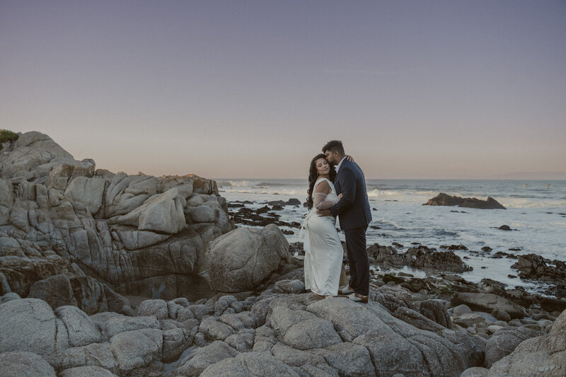 How to Elope in Big Sur couple standing on the beach in Big Sur at sunset