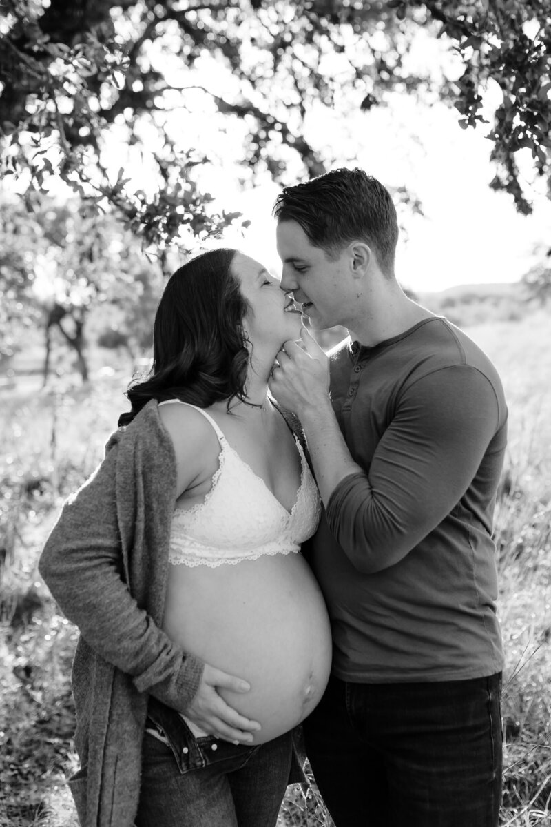 Pregnant woman and husband smiling at each other